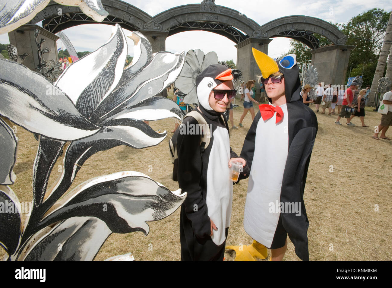 Zwei Männer, die als pinguine am Eingang des Parks auf dem Glastonbury Festival 2010, England, UK gekleidet. Stockfoto