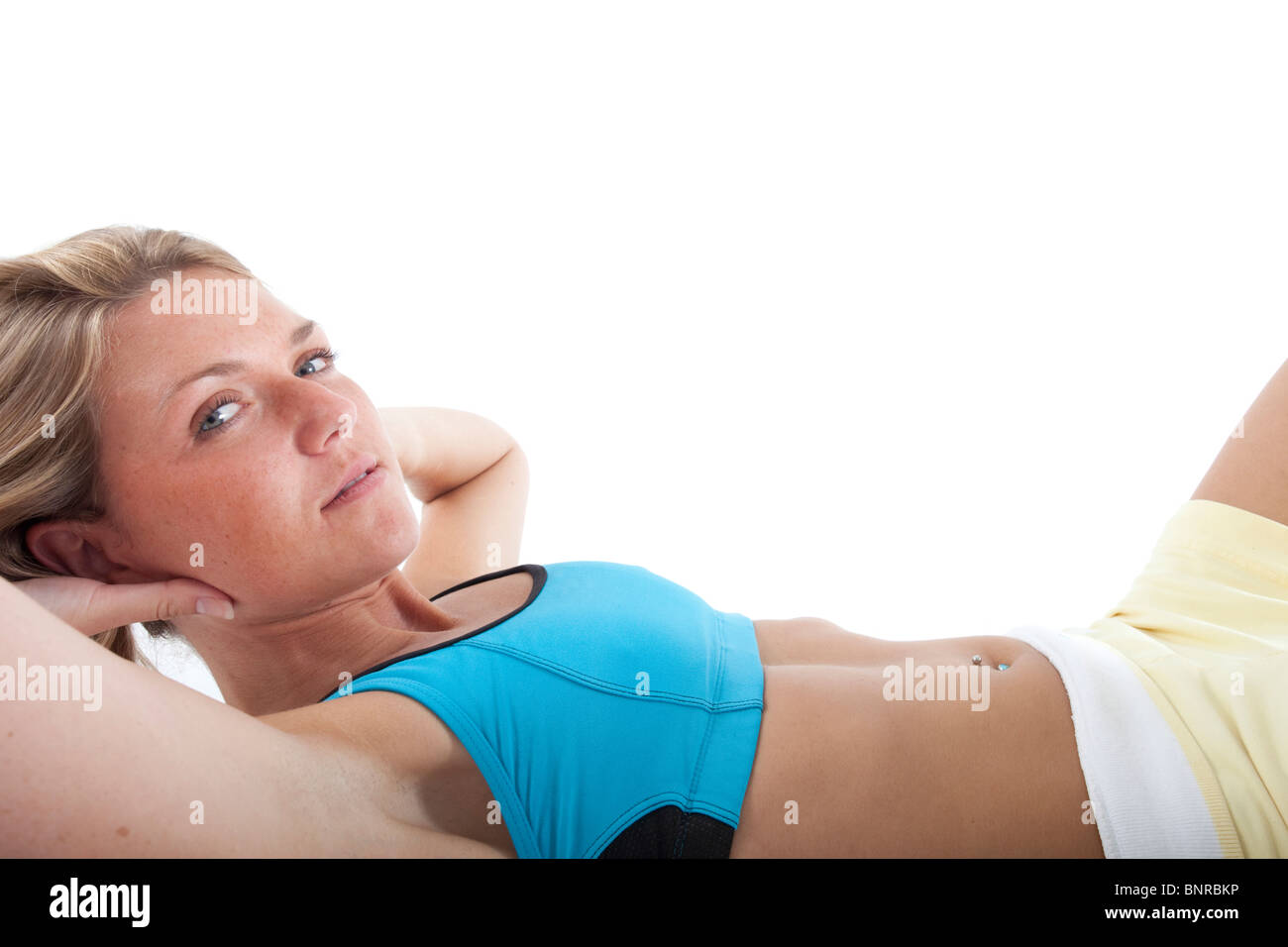 Sportlerin tut Sit Ups Stockfoto