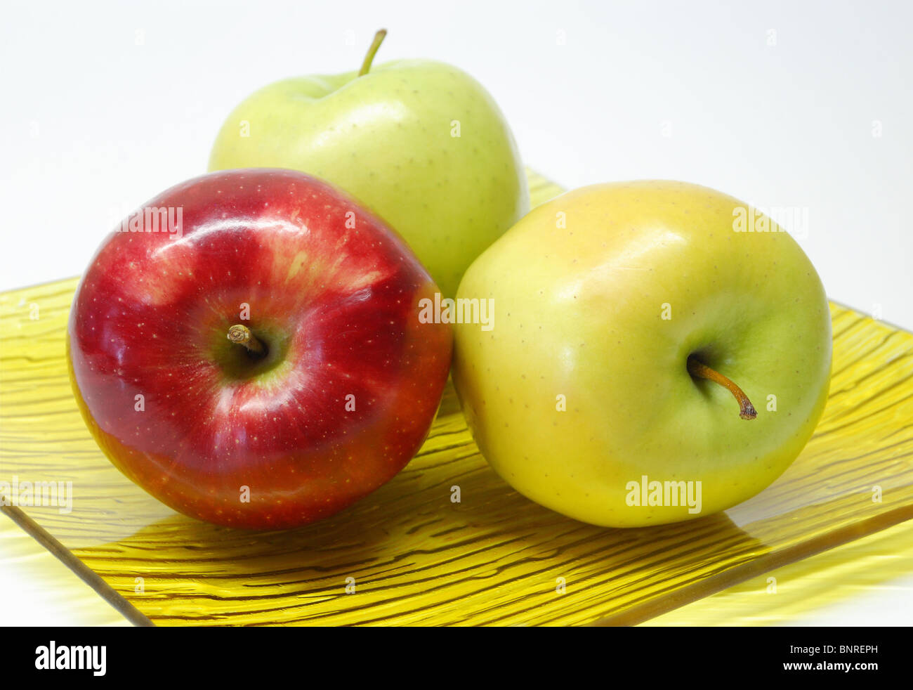 drei Äpfel in einer Platte Stockfoto