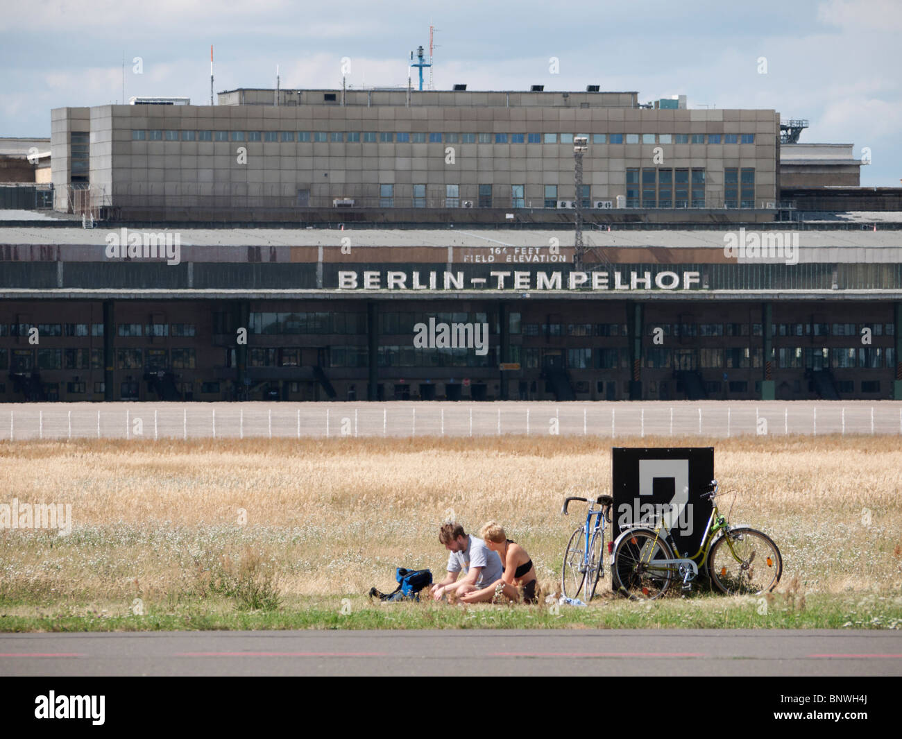 Menschen mit Picknick neben Start-und Landebahn am Neustadt öffentliche Tempelhofer Park auf dem Gelände des ehemaligen Flughafens Tempelhof in Berlin Deutschland Stockfoto