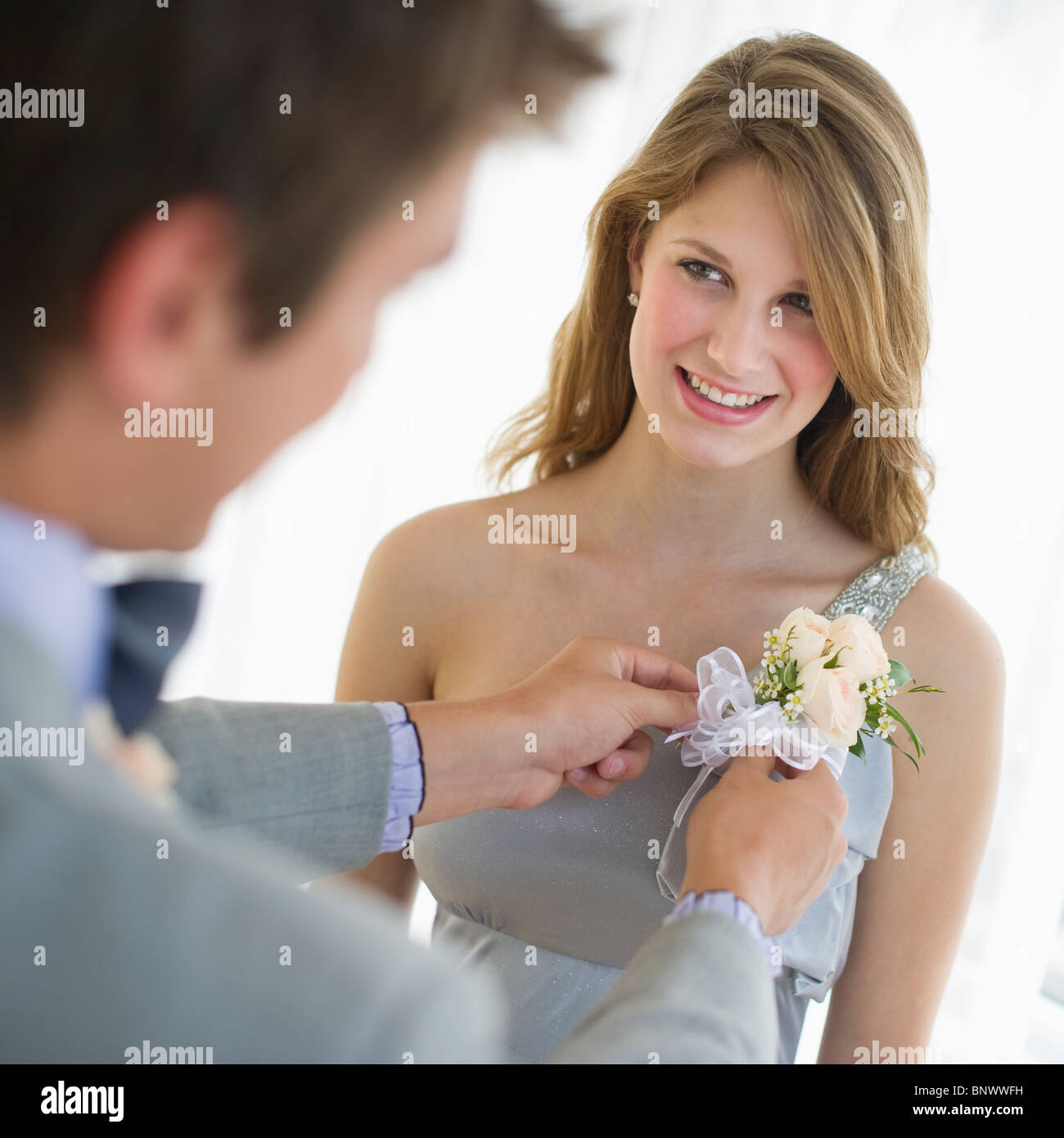 Mann pinning Corsage auf seinem Datum Prom Kleid Stockfoto