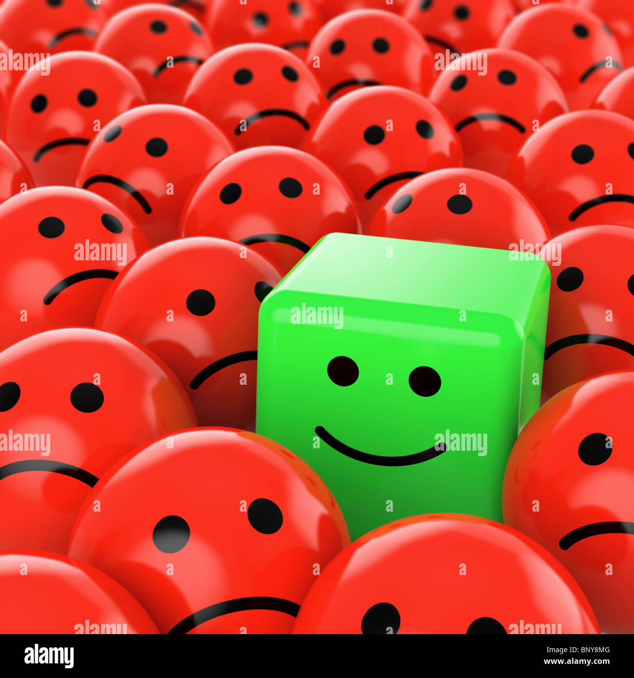 eine grüne happy Cube Smiley Unterschied zwischen vielen roten Sherical traurig andere als Konzept für einzigartige, optimistisch, positiv, Stockfoto