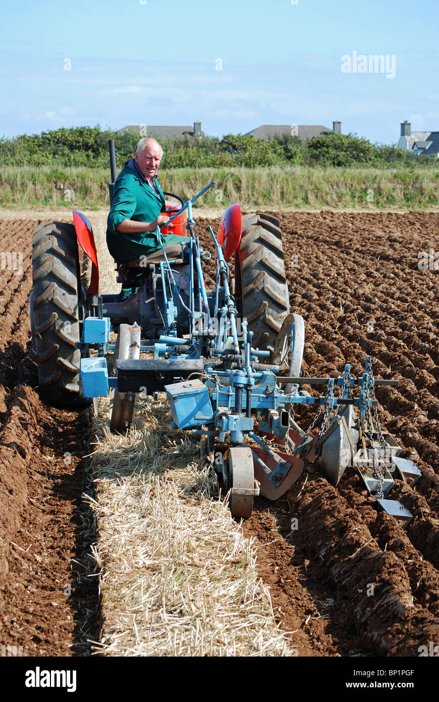 Landwirt mit einem Oldtimer-Traktor um zu pflügen ein Feld, Cornwall, uk Stockfoto