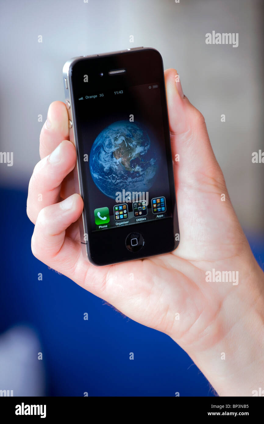 Apple Mac Iphone 4g in die Hand eines Mannes gehalten Stockfoto