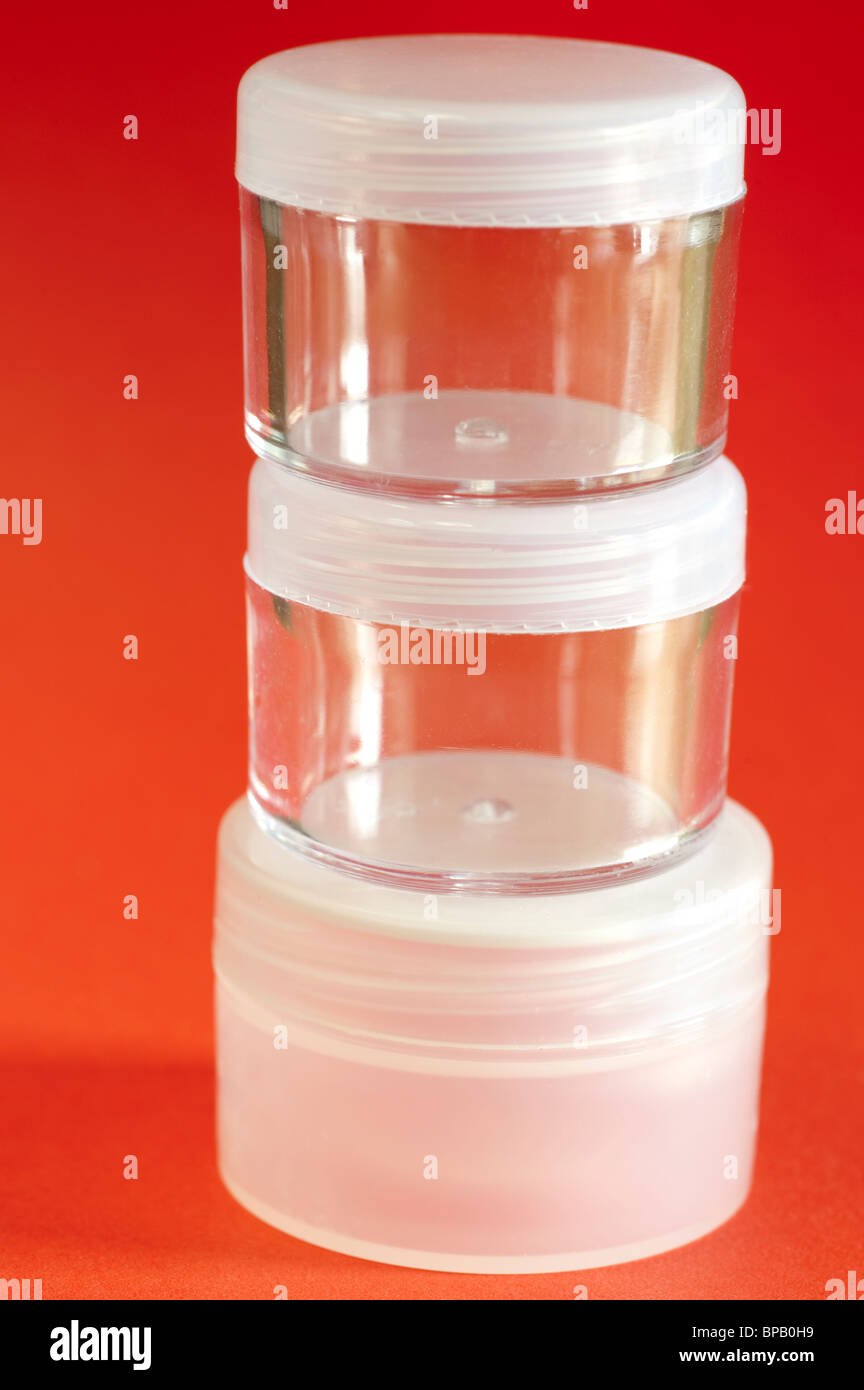 Drei kleine gestapelte kosmetische Kunststoffbehälter mit Schraubverschlüssen Stockfoto