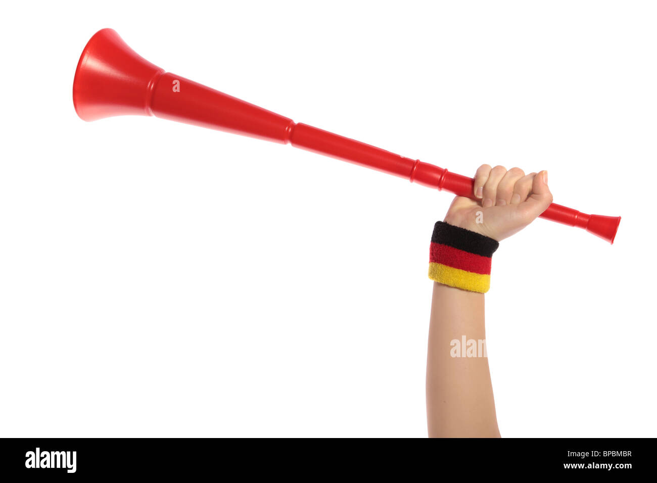 Eine menschliche Hand mit einem Schweißband in deutschen Farben halten eine Vuvuzela, die traditionelle Trompete der südafrikanischen Fans Stockfoto