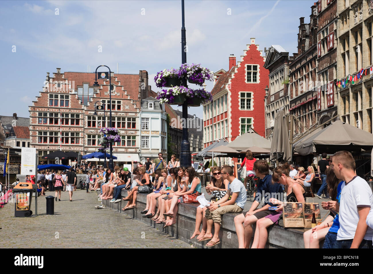 Graslei Quay, Gent, Ost-Flandern, Belgien, Europa. Studenten, die am Fluss Leie Kai im historischen Zentrum entspannend Stockfoto
