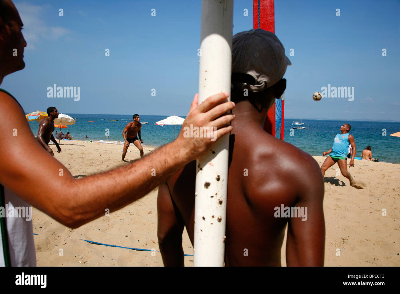 Männer spielen Fuß-Volleyball in Porto da Barra Beach, Salvador, Bahia, Brasilien. Stockfoto