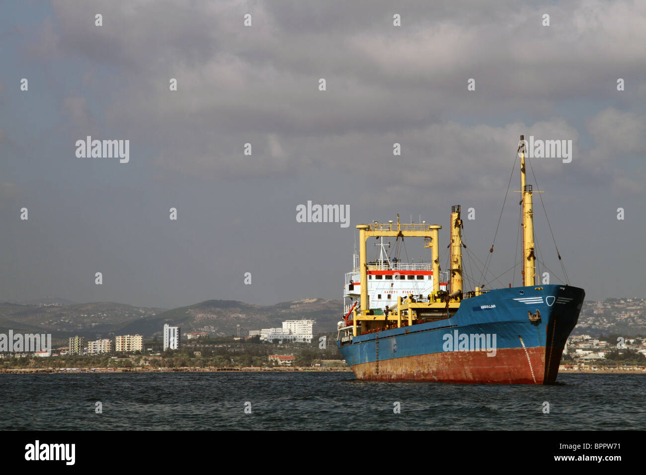 Ein Handelsschiff neben Tartous Hafen nehmen zwar auf einem Boot zur Insel Arwad Stockfoto