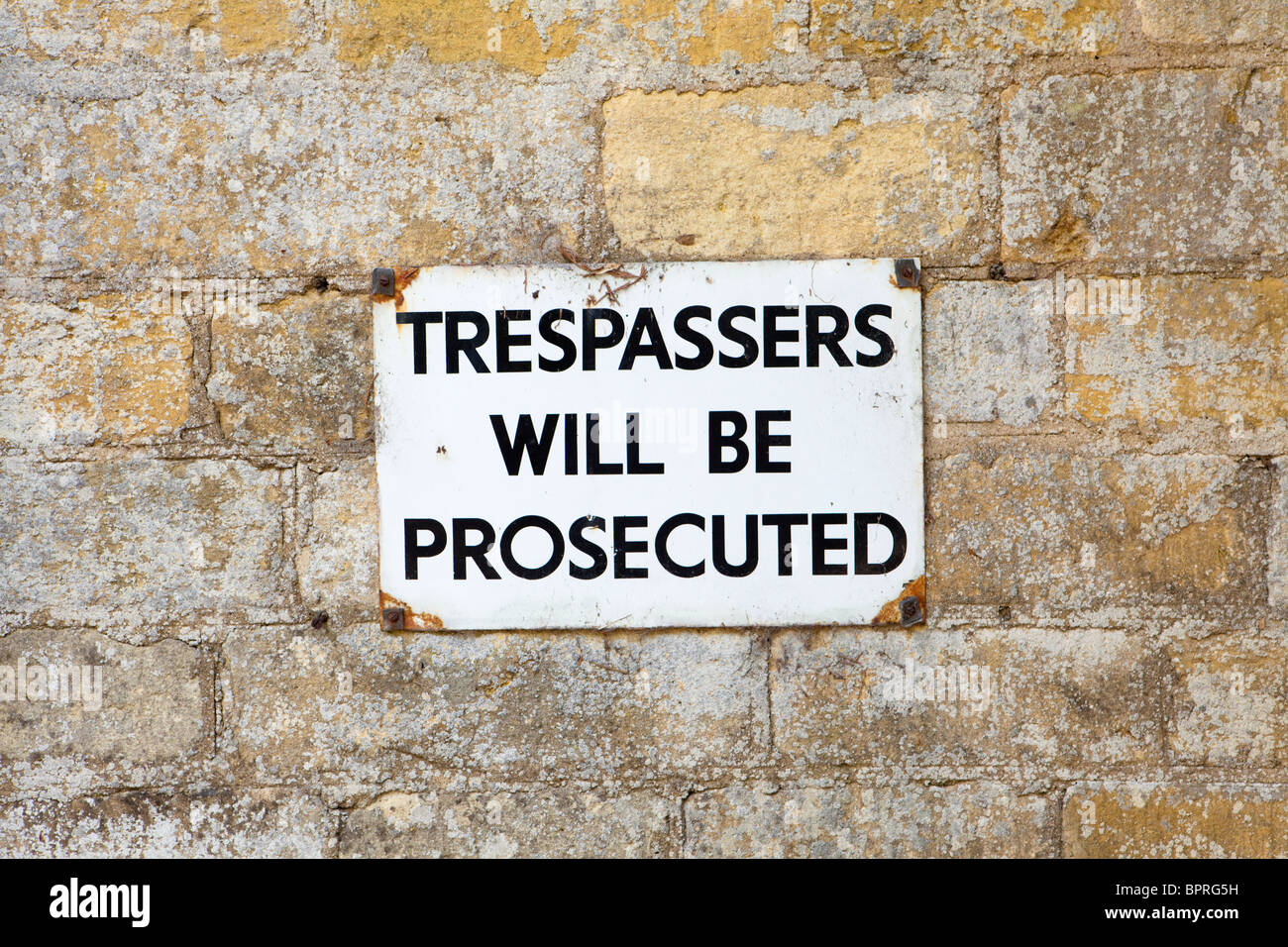 Eindringlinge werden strafrechtlich beachten Sie auf die Cotswold Steinwand an Toddington, Gloucestershire Stockfoto