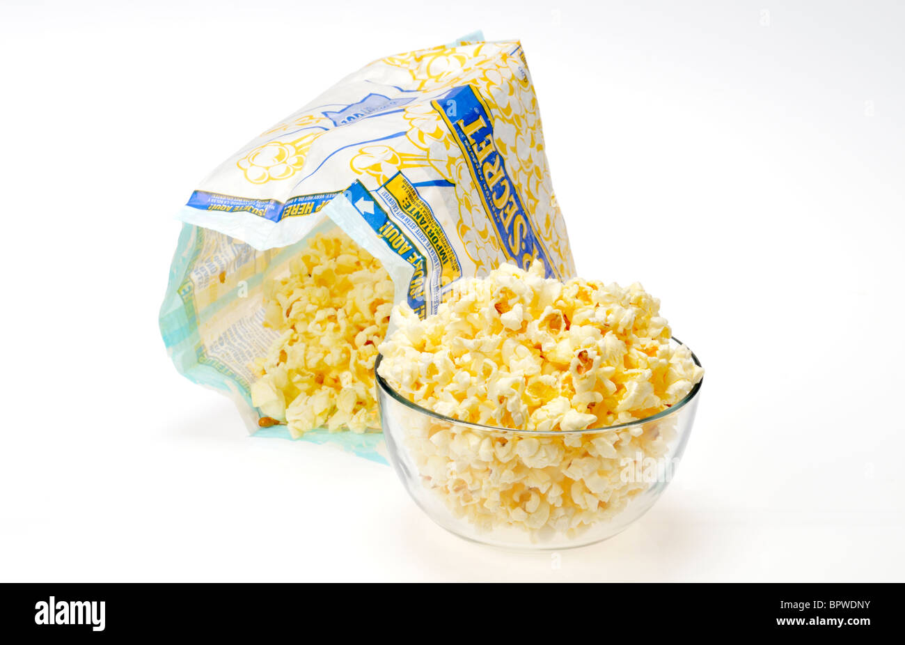 Beutel der Pop Secret Mikrowelle Popcorn mit etwas Popcorn in Glasschale auf weißem Hintergrund geöffnet, Ausschnitt. Stockfoto