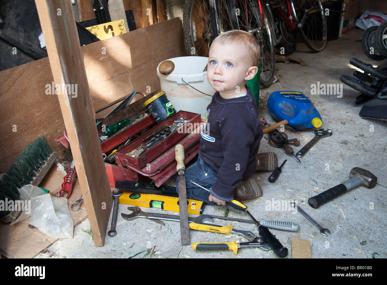 Baby Junge (18 Monate alt) Kleinkind spielt mit einem Werkzeugkasten, Hampshire, England. Stockfoto