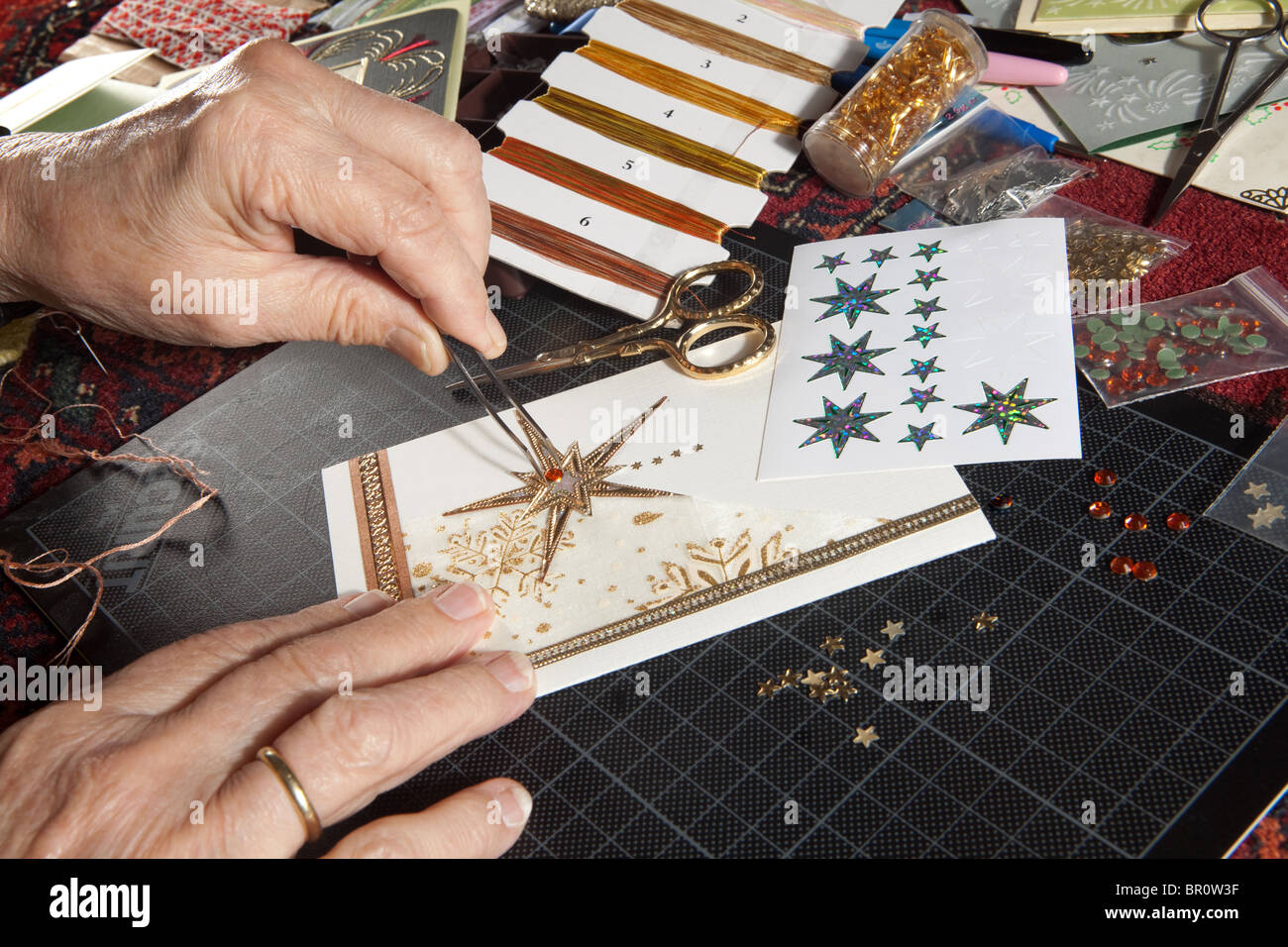 Hände einer Frau basteln und Schrott-Buchung Weihnachtskarten Stockfoto
