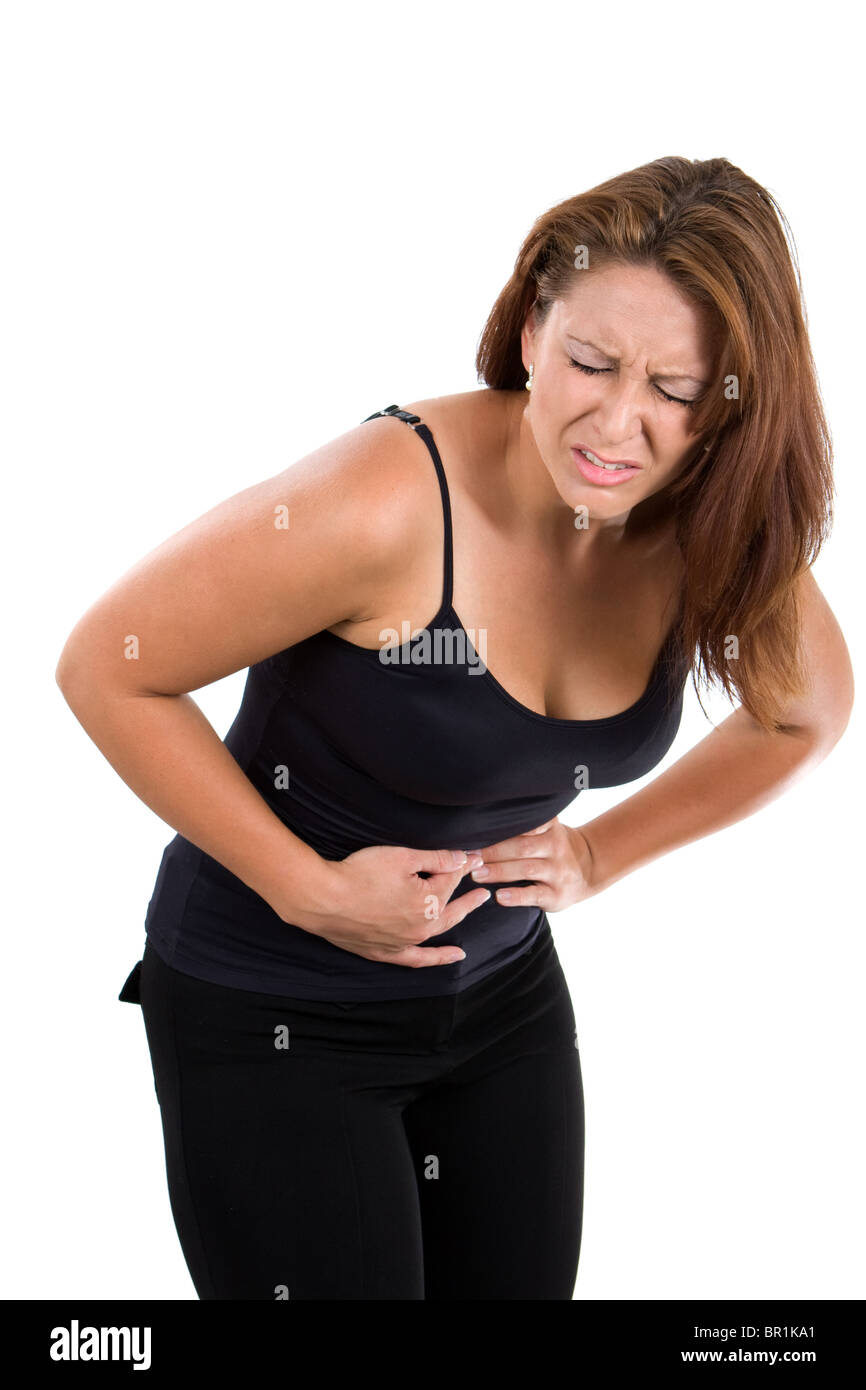 Frau hält ihren Bauch und beugt sich über Schmerzen von Bauchkrämpfen. Stockfoto