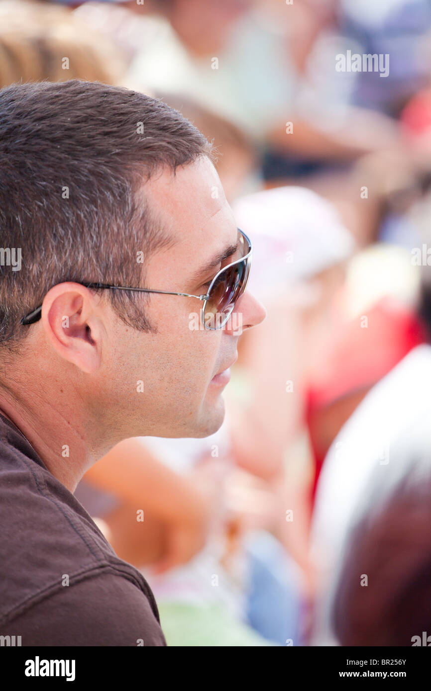 Attraktiver Mann mit Sonnenbrille bei einem Outdoor-Show. Stockfoto