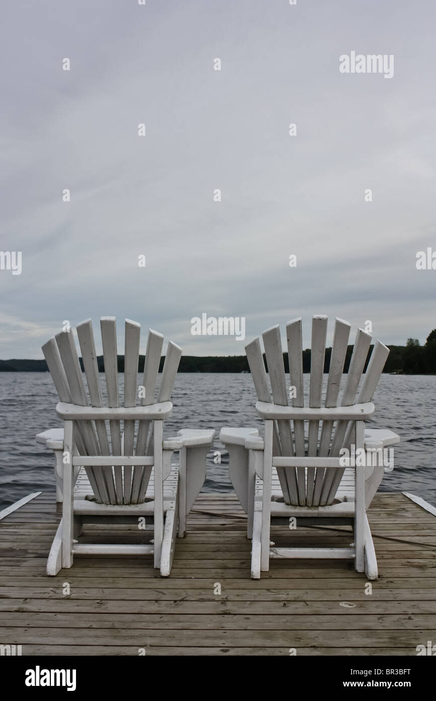 weiße Holz Rasen Stuhl im freien See Deck bewölkt Stockfoto
