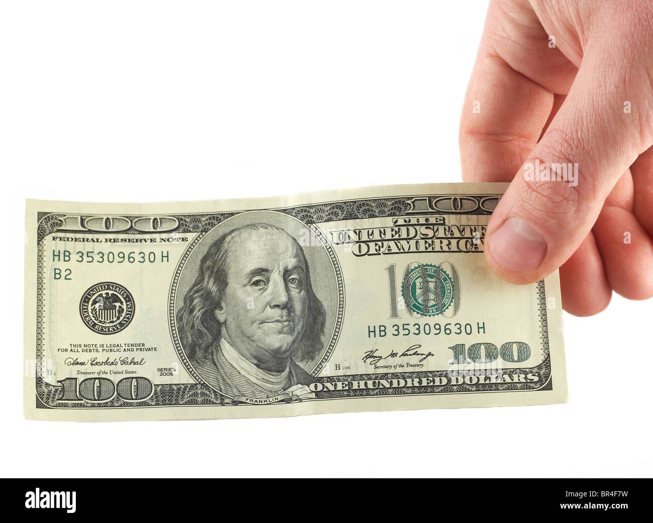 Hand mit $100 Banknote isoliert auf weiss Stockfoto