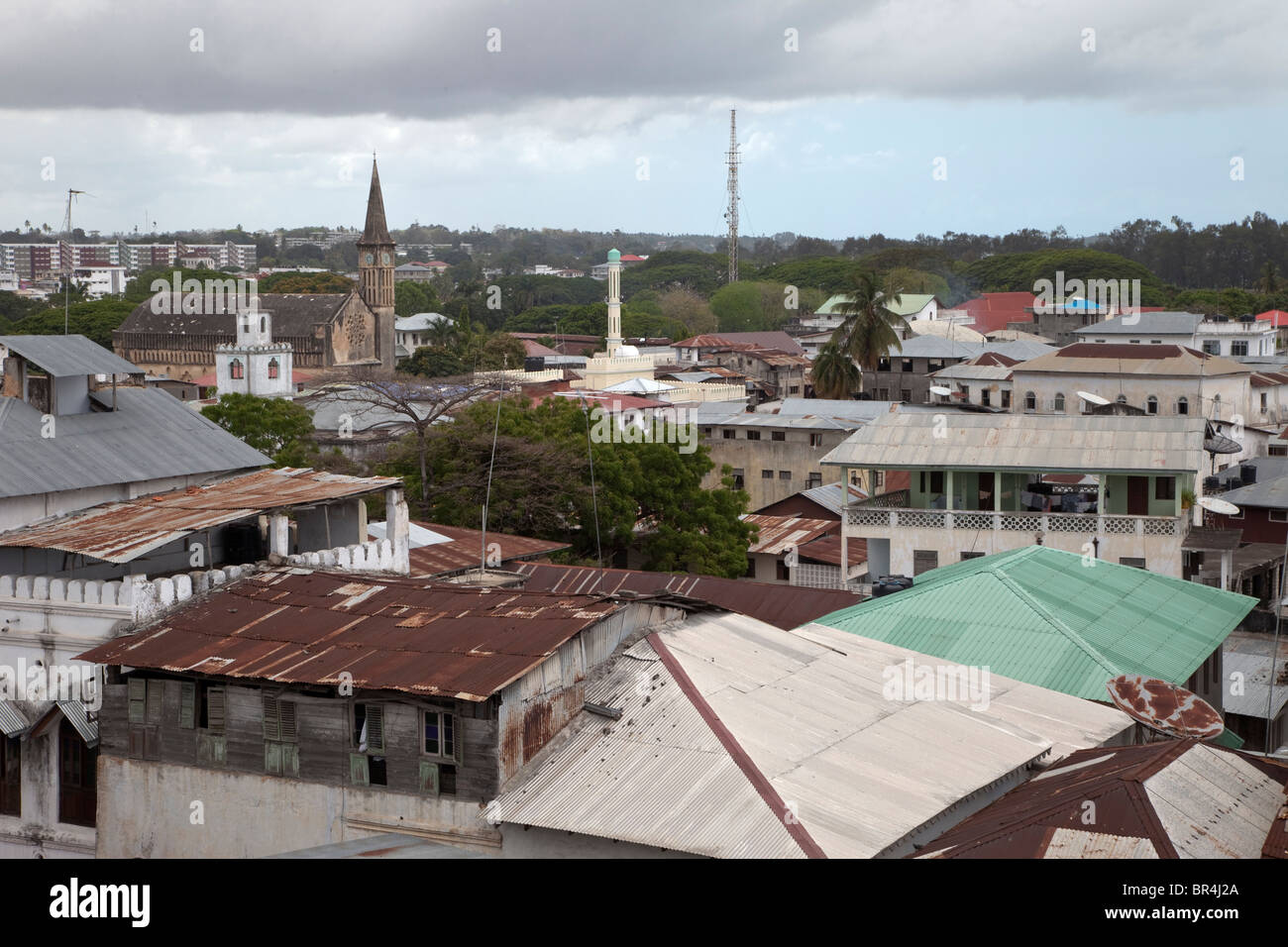 Stone Town, Sansibar, Tansania. Dächern. Katholische Kirche, St. Joseph ibadhischen Minarett auf Links, Sunni Minarett in Mitte. Stockfoto