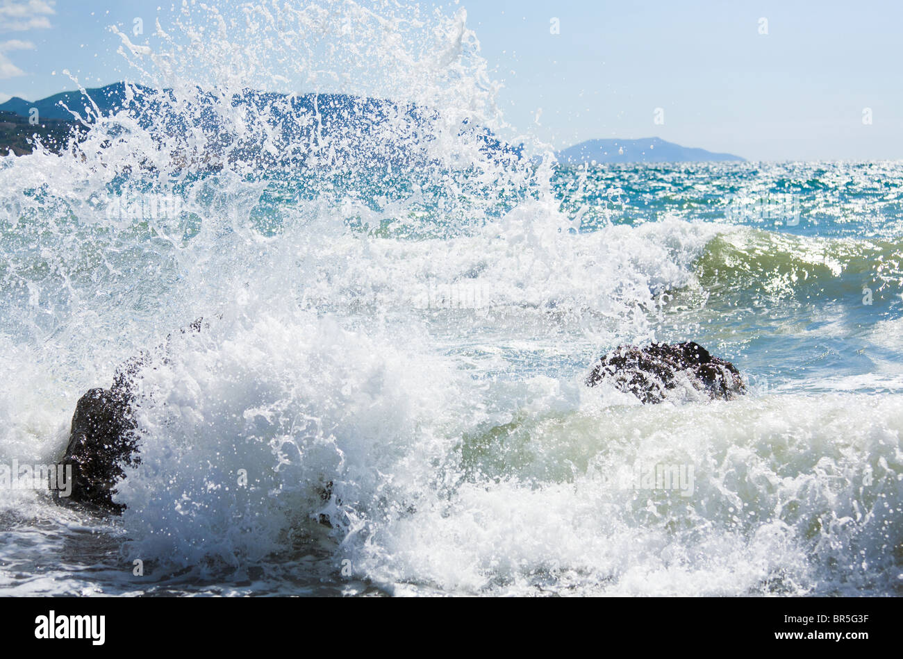 Meer Surfen Welle brechen auf Küste und Meganom Kap am Horizont rechts (Krim, Ukraine) Stockfoto