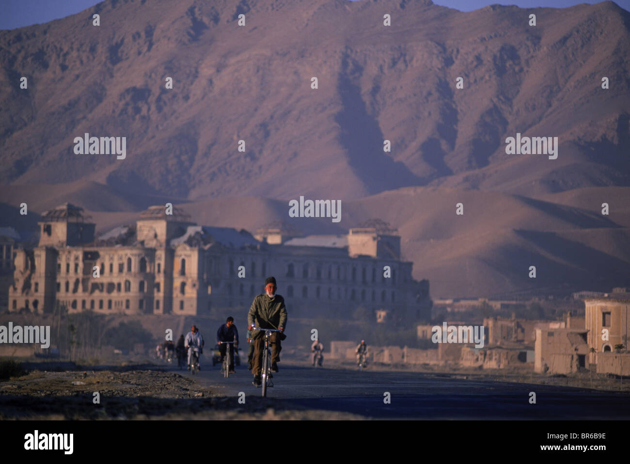 Afghanen auf Fahrräder MakKe bis den frühen Morgen Verkehr auf Darulaman Boulevard. unterhalb der Ruine der Darulaman-Palast in Süd- Stockfoto