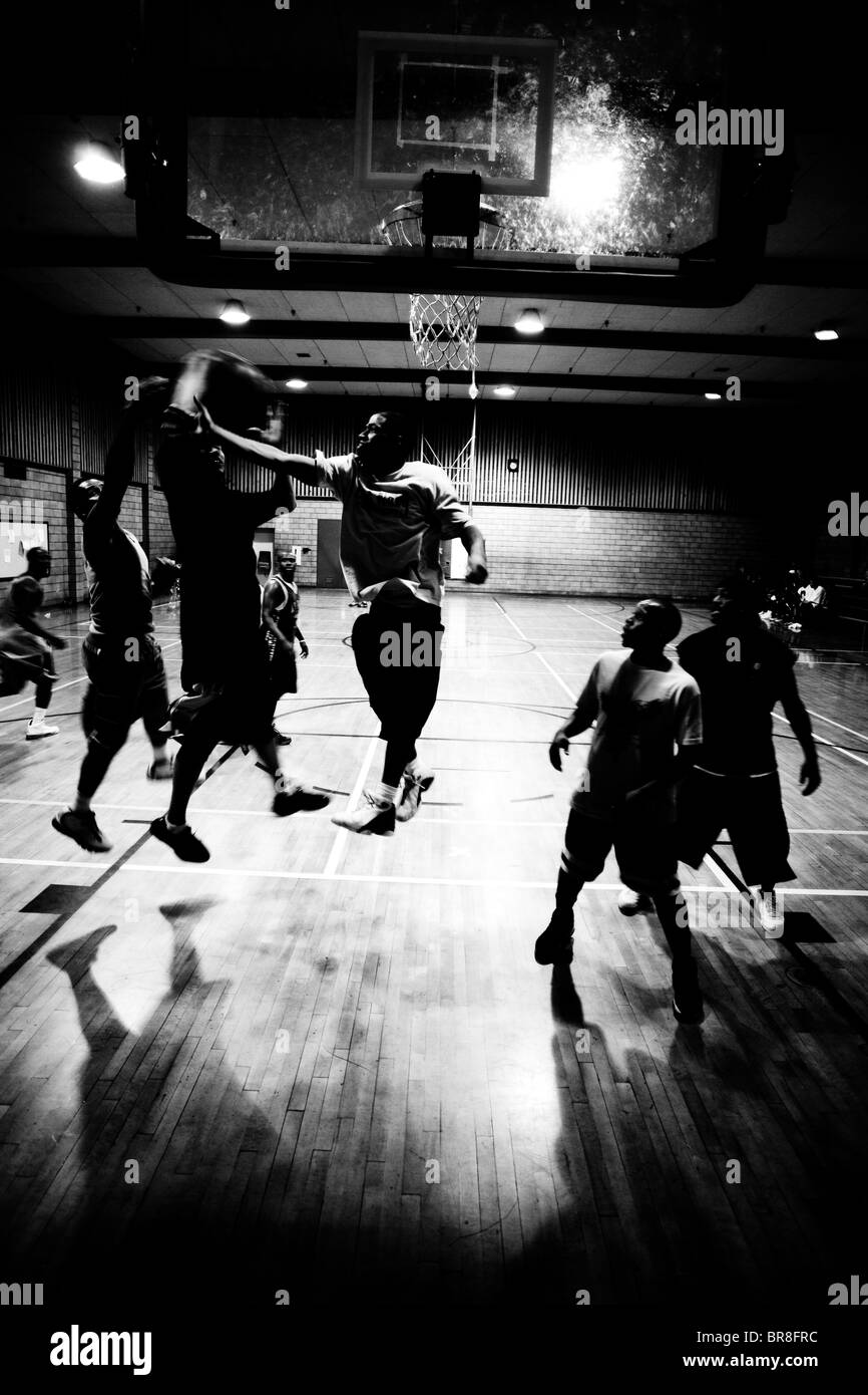Gruppe von Jungs in einer innerstädtischen Turnhalle Basketball zu spielen. Stockfoto