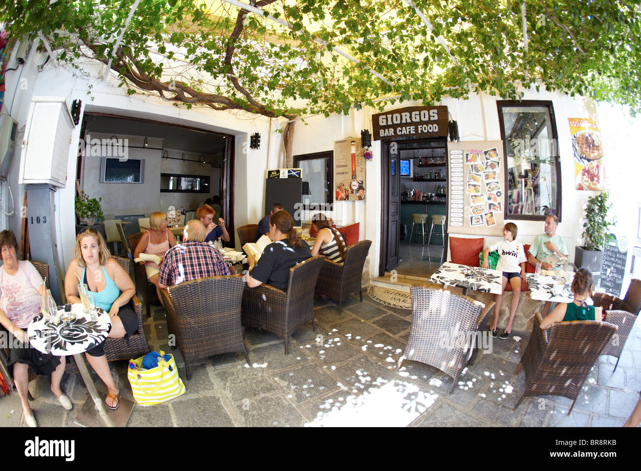 Touristen sitzen In A Bar-Cafe In Lindos Rhodos griechische Inseln Griechenland Hellas Stockfoto