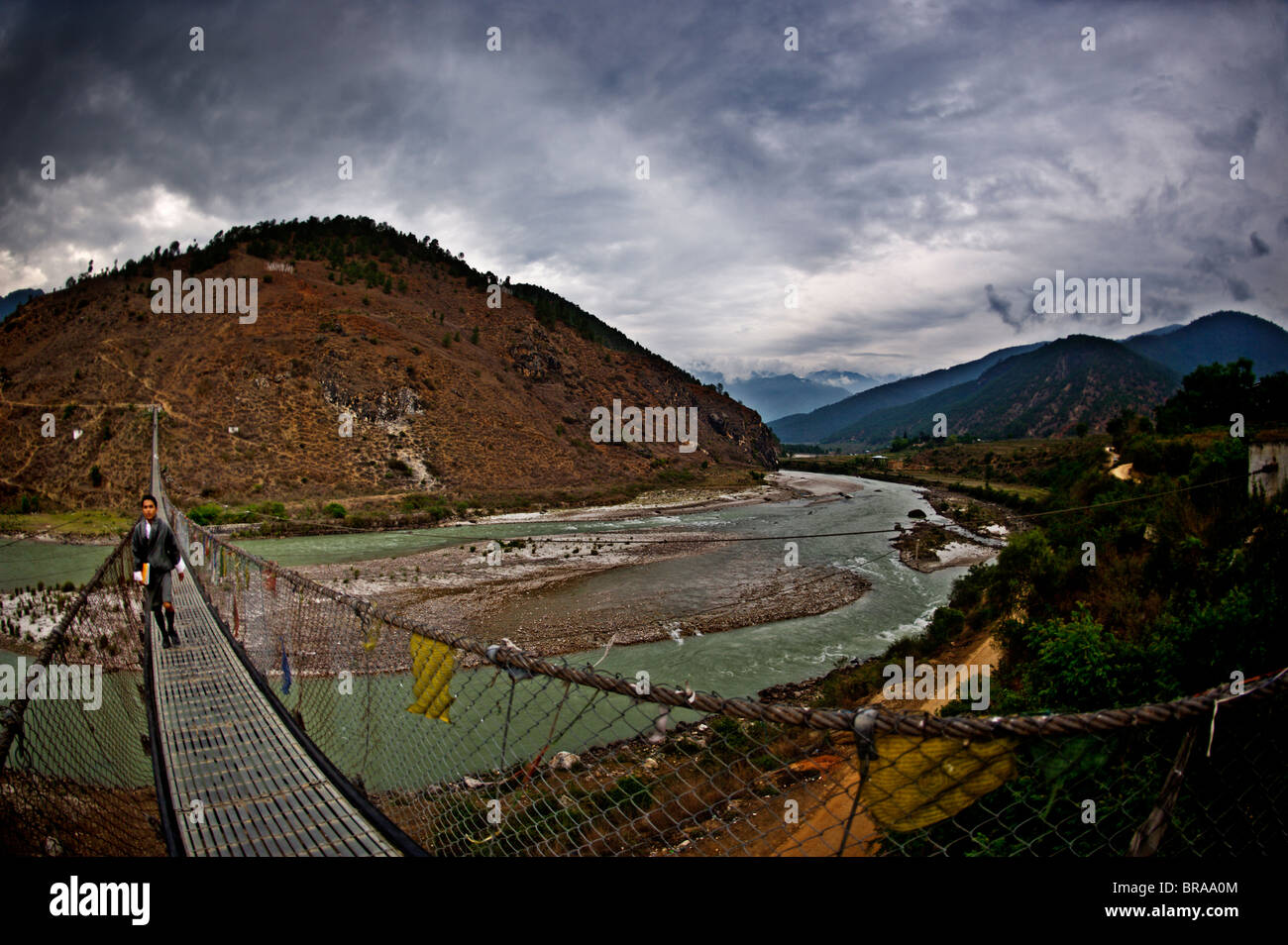 Ein Student überquert Bhutans längste Hängebrücke, Panakha, Bhutan, Himalaya, Asien Stockfoto