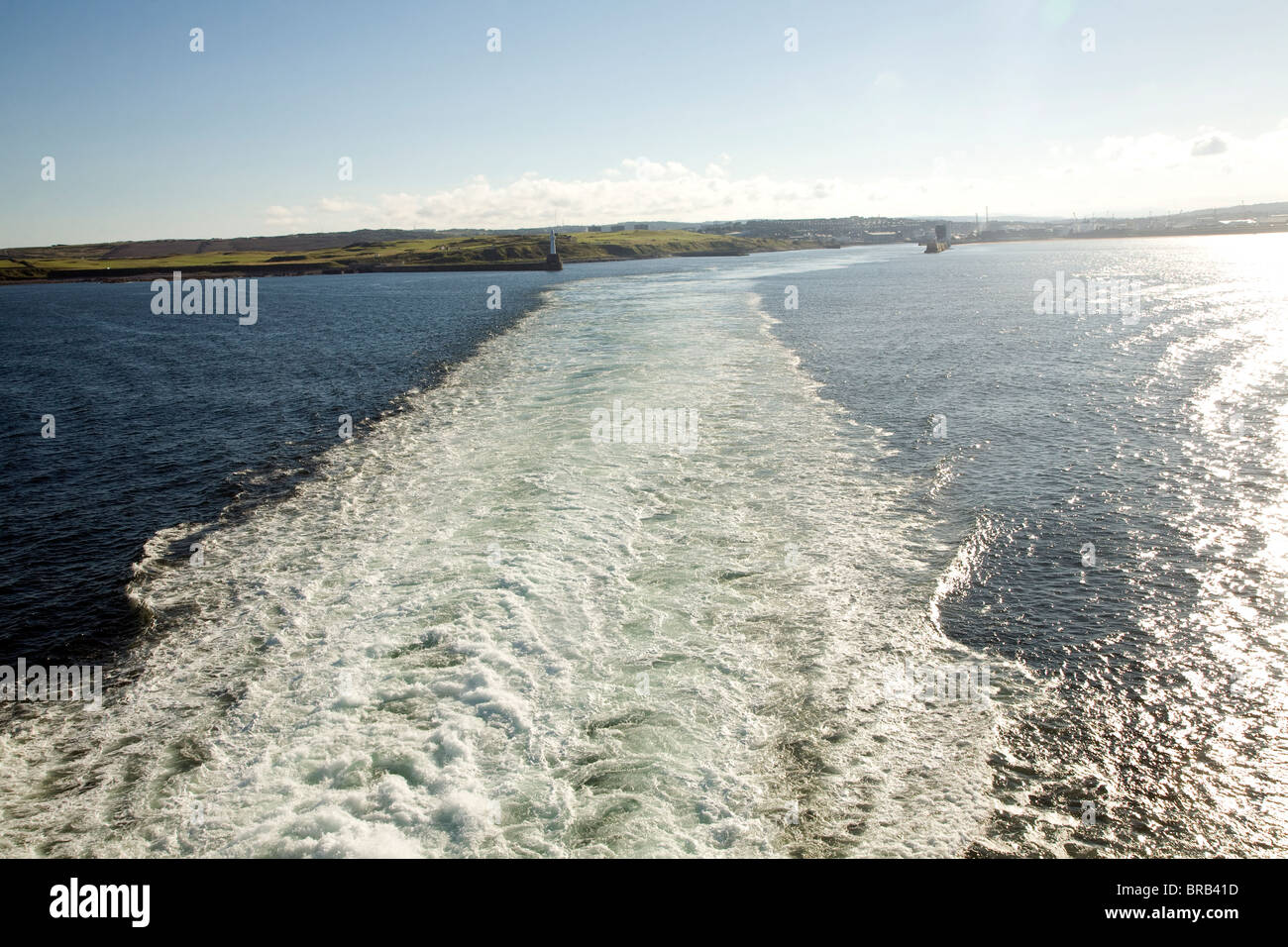 Großen Gefolge des Schiffes auf See in der Ferne Land hinterlassen Stockfoto