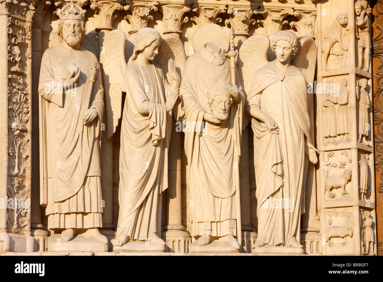 Statuen der Kaiser Constantine und Saint-Denis mit seinem Kopf, Jungfrau-Tor, darunter die Kathedrale Notre Dame, Paris, Frankreich Stockfoto