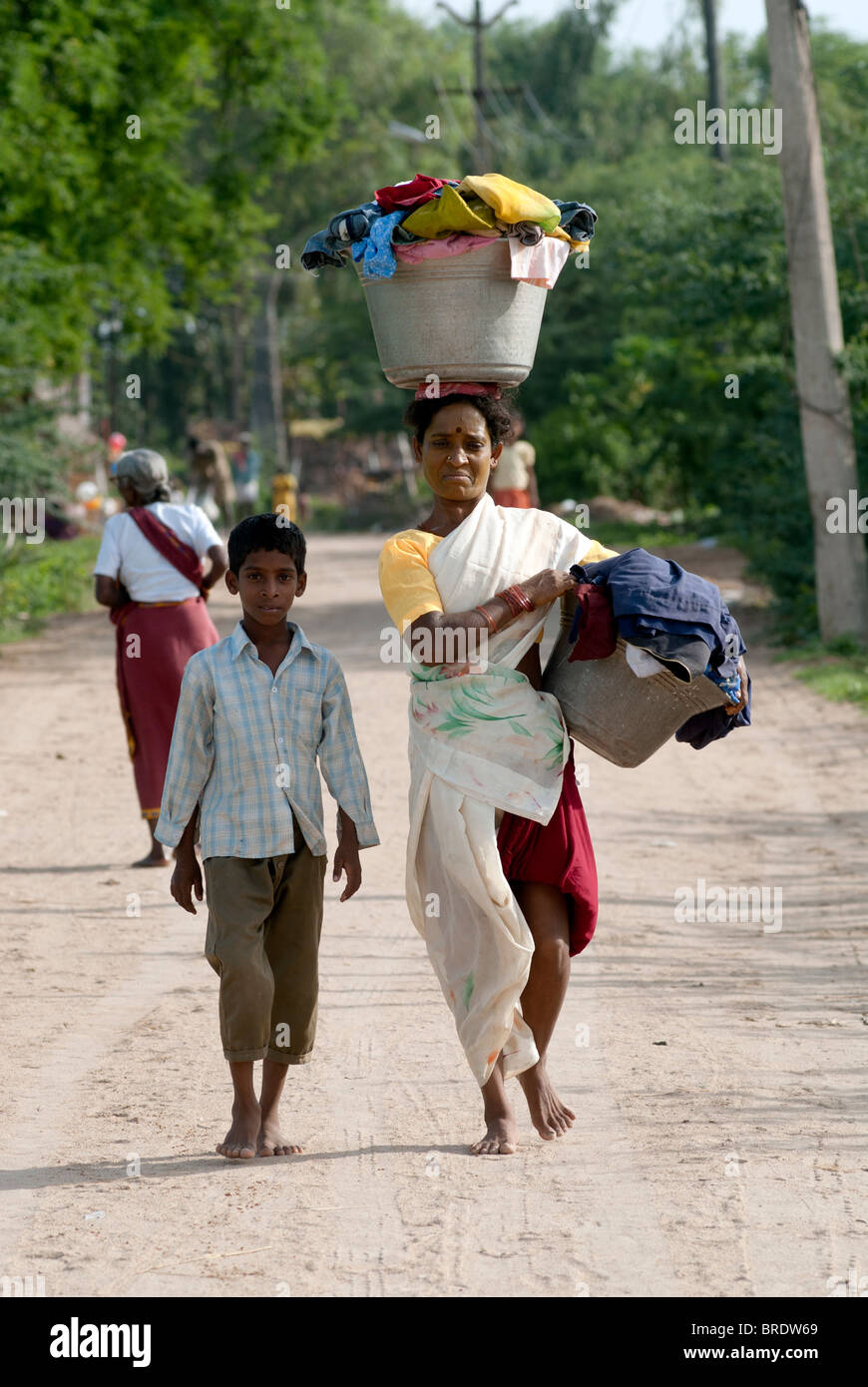 Waschmaschine-Frau, die gewaschene Wäsche zusammen mit ihrem Sohn bei Sevelimedu in der Nähe von Kanchipuram, Tamil Nadu. Stockfoto