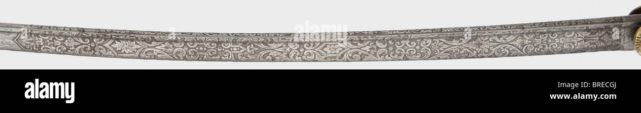 Ein Präsentationssäbel mit Damaszener Klinge, an einen preussischen Artillerie-Offizier Gebogene Rohrschlinge aus geschmiedetem Damaskus (geschärft, gereinigt) mit Geläuten und dekorativer Blumenätzung auf der oberen Hälfte zusammen mit der Widmung, 'J.W. Colsman s/l R. Bäuerle - 1910" mit einem Studentenwohnschaftslogo und dem Makerzeichen "WKC". Vergoldeter Knöchelknopfhill mit Löwenkopfgriffkappe (mit roten Glasaugen) und üppiger Blumendekoration im Reliefformat. Die obverse Schlanke trägt gekreuzte Kanonenfässer. Schwarze Schärfhaut Griffabdeckung mit Drahtwicklung. Schabb aus schwarz lackiertem Stahl, Stockfoto