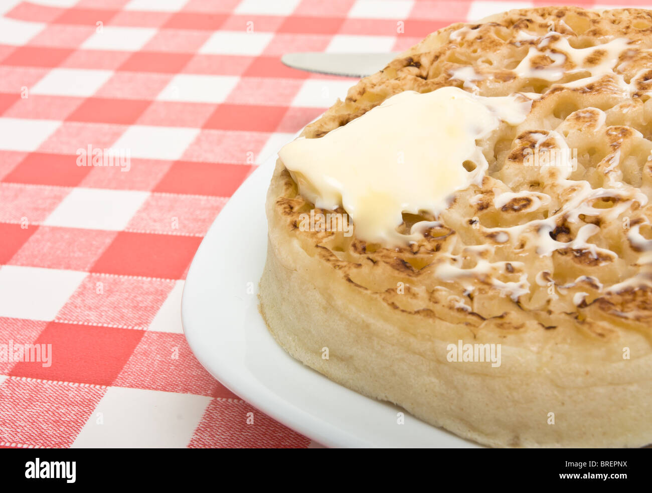 Traditionelle englische Hot Buttered Fladen mit Butter schmelzen. Stockfoto