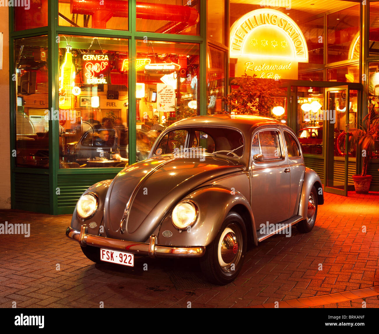 1956-VW-Käfer vor einer Burger-Bar in der Nacht mit Leuchtreklamen Stockfoto