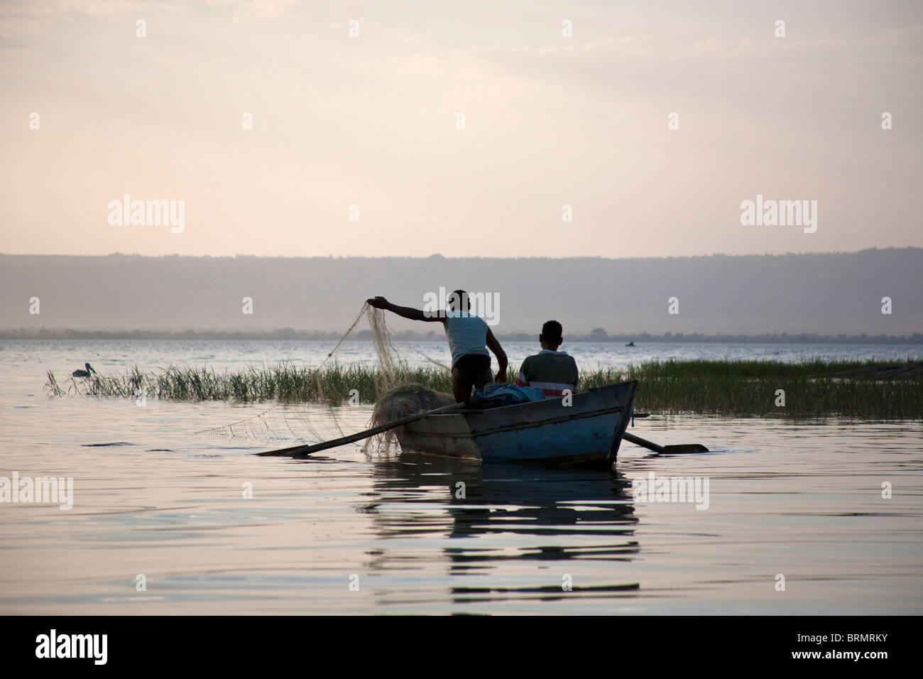 Fischer in ihrem Boot Fischen mit einem Netz in der Abenddämmerung auf See Awassa Stockfoto