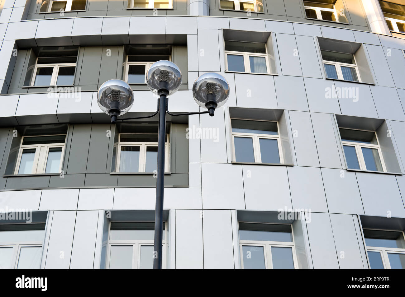 eine moderne Straßenlaterne gegen ein modernes Gebäude Stockfoto