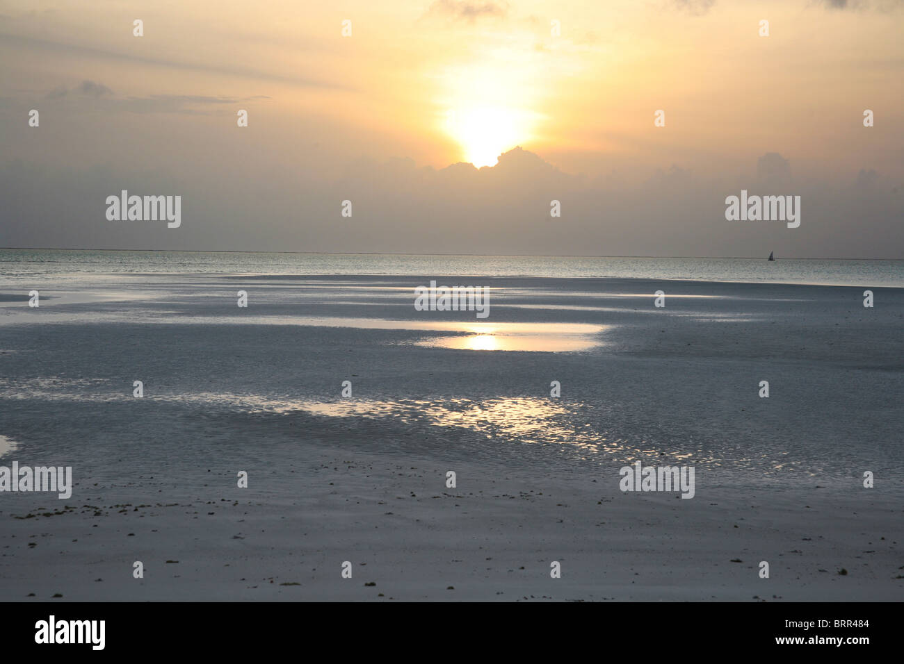 Einsame Insel Strand im Morgengrauen mit entfernten Dhows am Meer Stockfoto