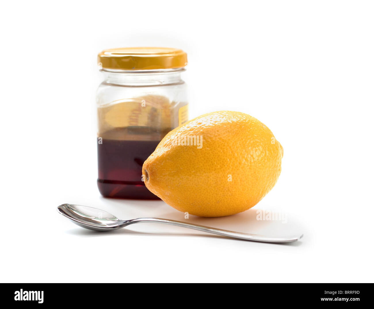 Zitrone und Honig mit Löffel Stockfoto