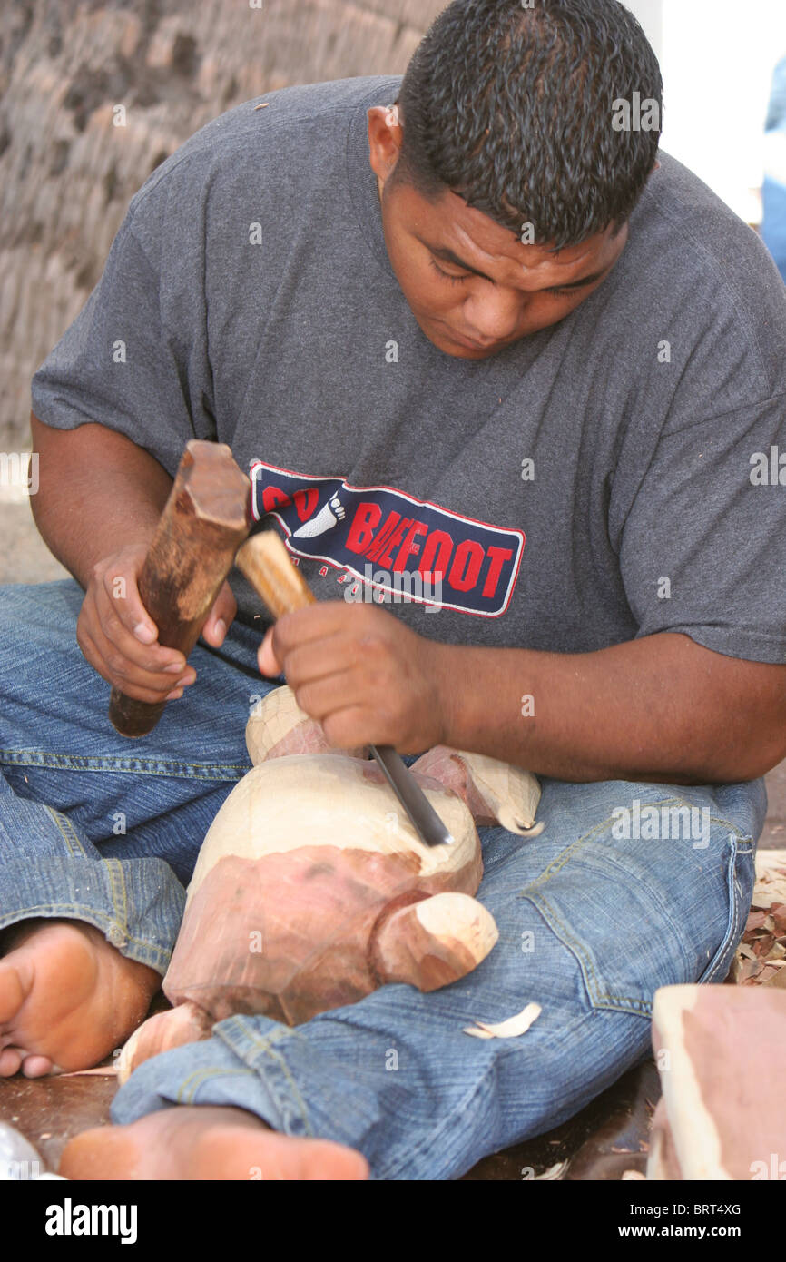Lokaler Mann im Lahaina Maui Hawaii schnitzen Holz- Artefakte für den Verkauf an Touristen. Auf der pazifischen Insel Kultur. Stockfoto