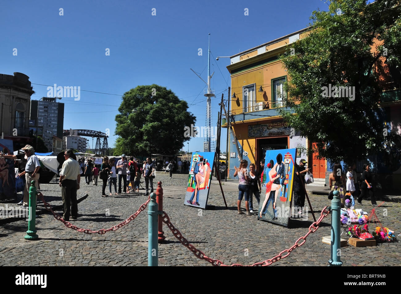 Leute standen um Tango-Themen Ausschnitte auf dem Kopfsteinpflaster am Riverwalk, südlichen Ende Caminito, La Boca, Buenos Aires Stockfoto