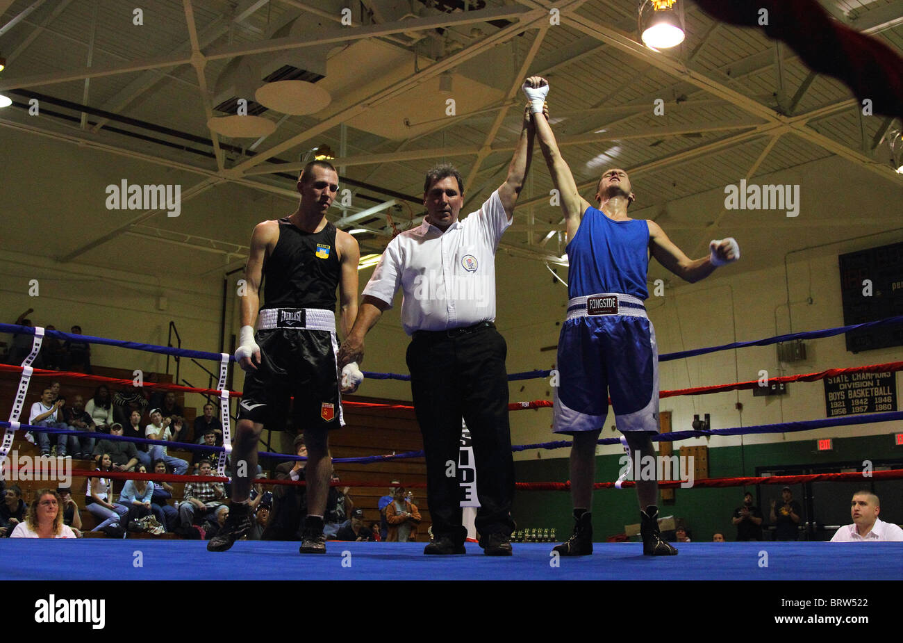 Ringrichter hält Arm Boxer in den Ring nach einem Boxkampf gewinnen Stockfoto