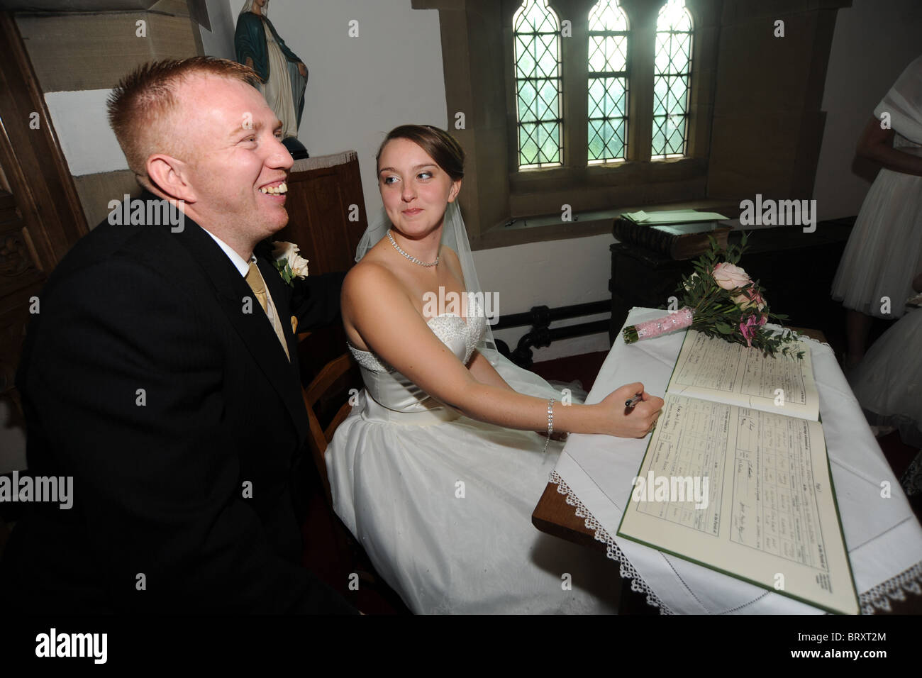 Braut und Bräutigam just married, Unterzeichnung des Registers Stockfoto