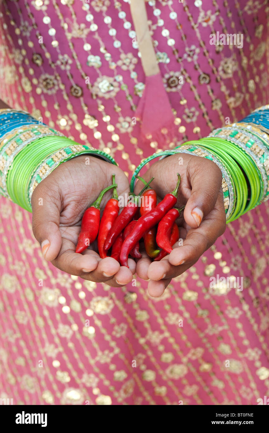 Indische Mädchen mit roten Chilischoten in hohlen Hand Stockfoto