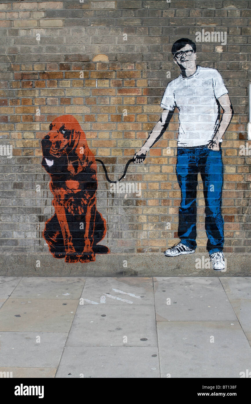 Mann mit Hund Schablone Graffiti Banksy Stil, Shoreditch London Stockfoto
