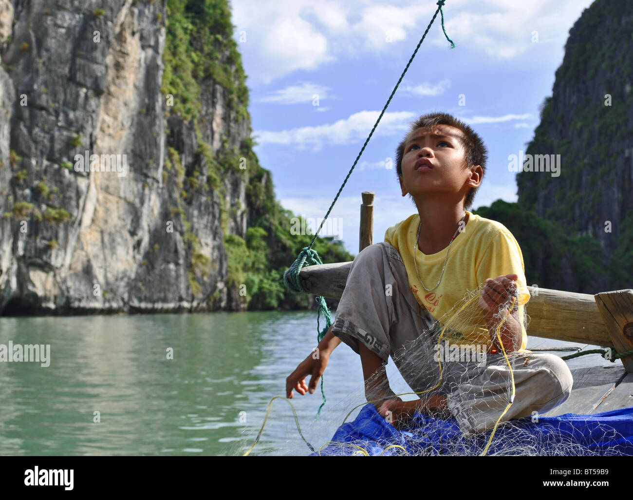 Junge, Fischen in der Ha Long Bucht, Vietnam Stockfoto