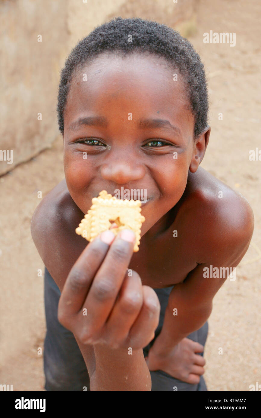 Malawi-Boy lächelnd mit Cookies Stockfoto
