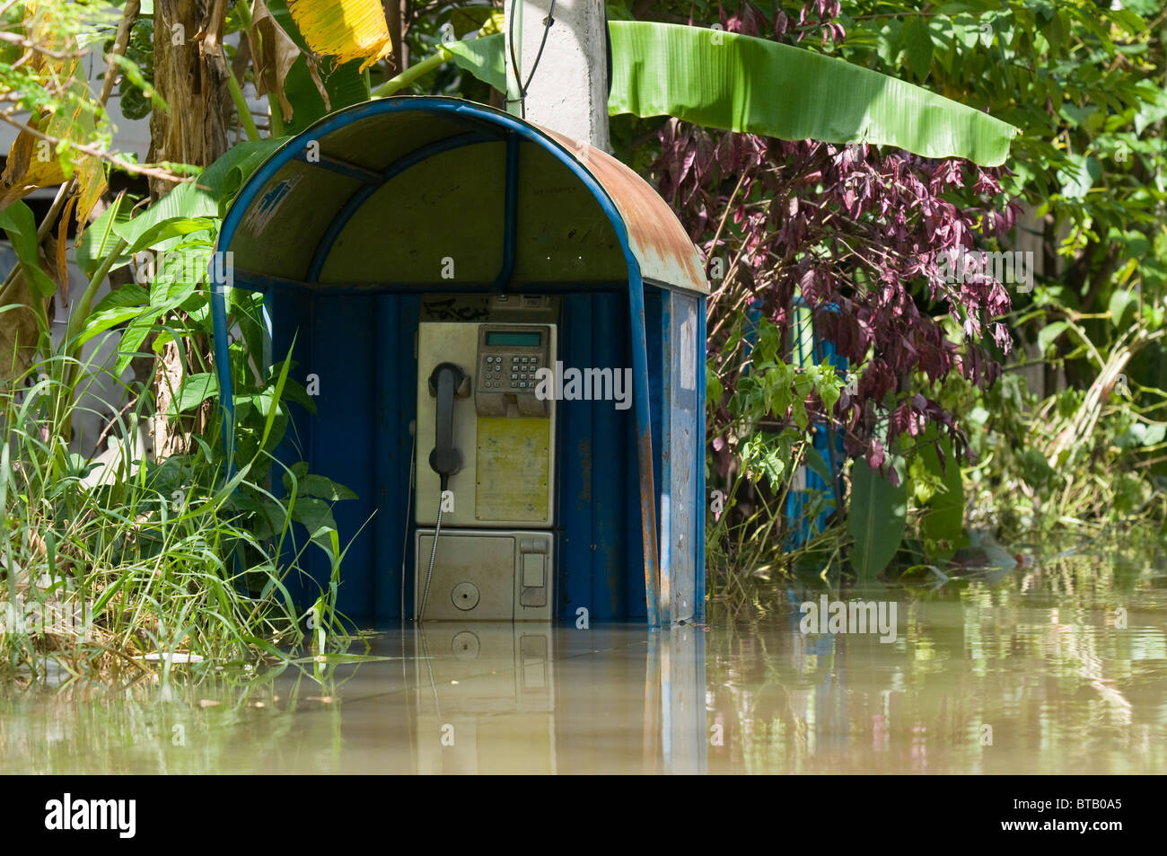 Telefonzelle in einer überfluteten Straße während der Oktober 2010 Überflutung von Nakhon Ratchasima in Thailand. Stockfoto