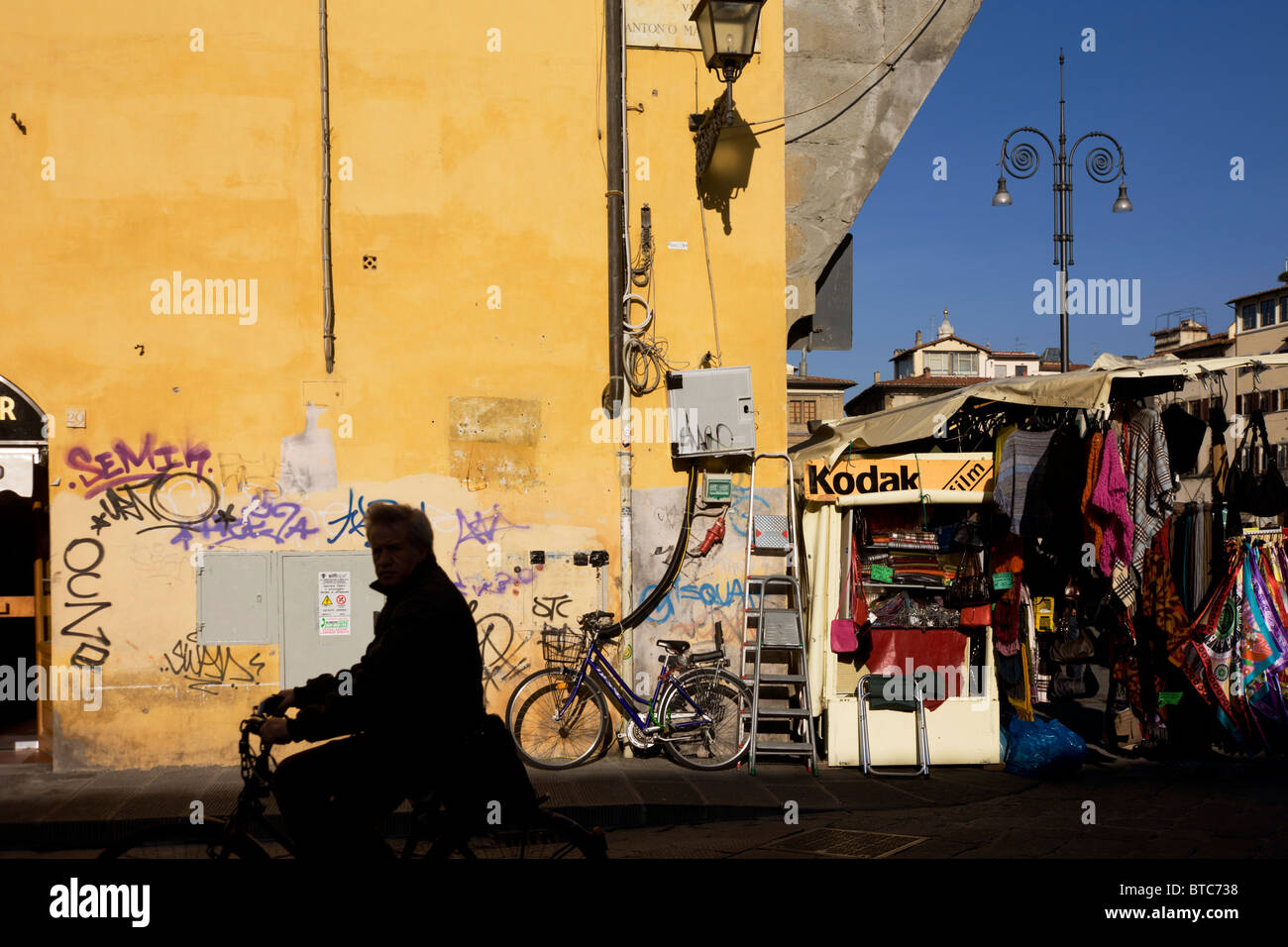 Radfahrer und Graffiti Straße Ecke und Tourist-Kiosk in der Nähe von Florenz Piazza Santa Croce. Stockfoto