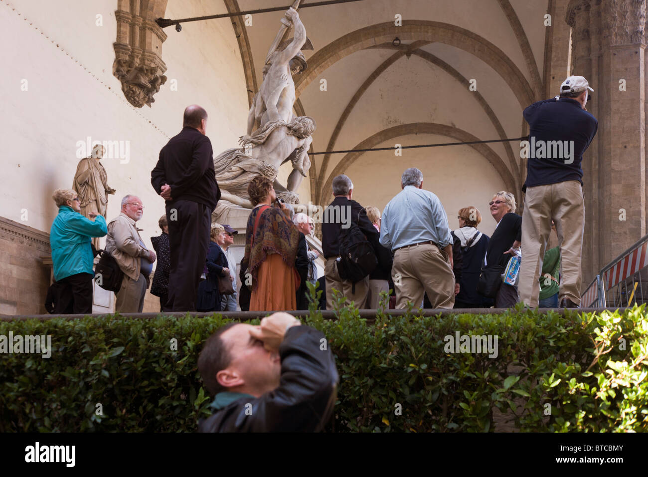 Eine Reisegruppe bewundert Renaissance Statuen in Florenz die Loggia dei Lanzi, Piazza della Signoria. Stockfoto