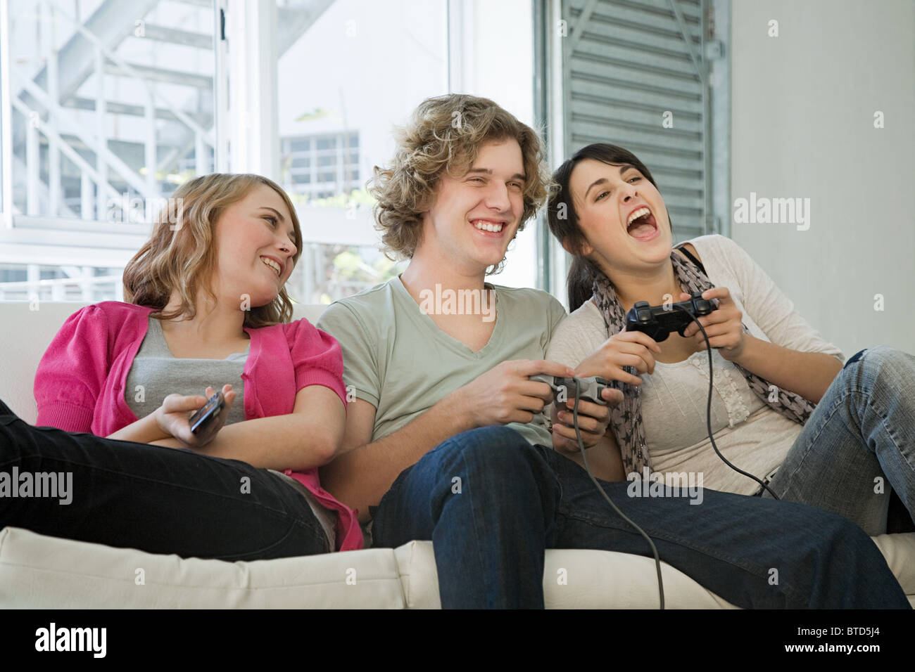 Jugendliche spielen auf Spiele-Konsole Stockfoto
