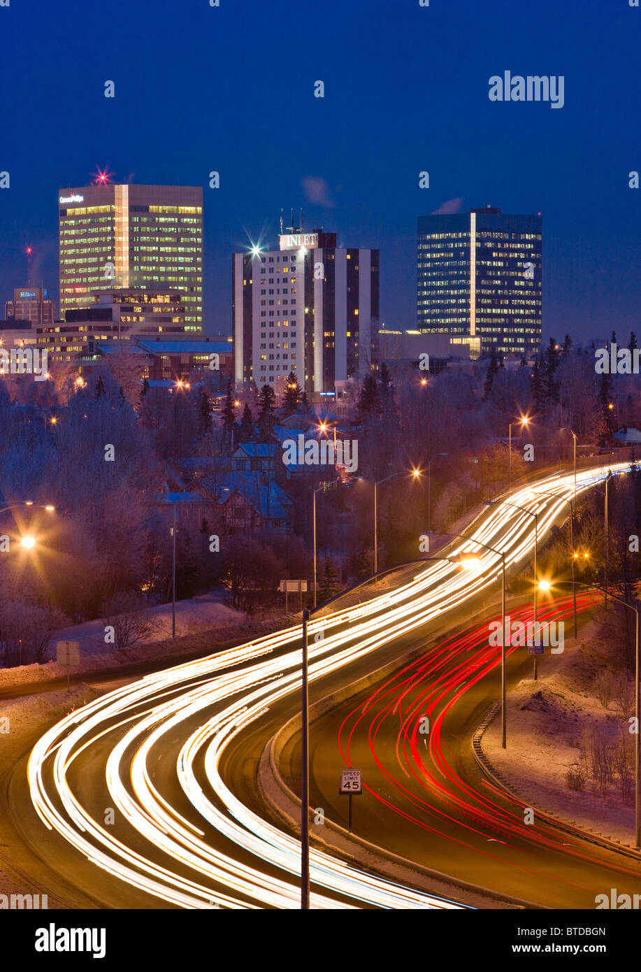 Twilight-Blick auf Verkehr auf Minnesota Blvd. mit Downtown Anchorage im Hintergrund, Yunan Alaska Winter/n Stockfoto